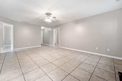 the living room and dining room in a new home with tile flooring