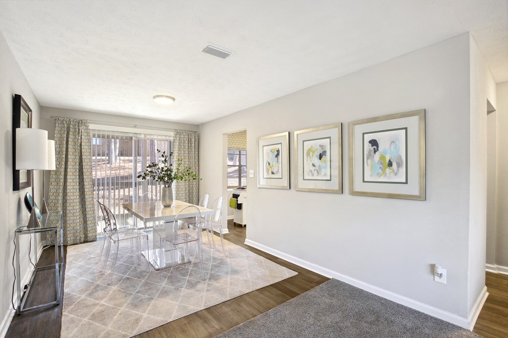 an open living room and dining room with a table and chairs