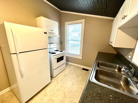 a kitchen with a sink and a refrigerator