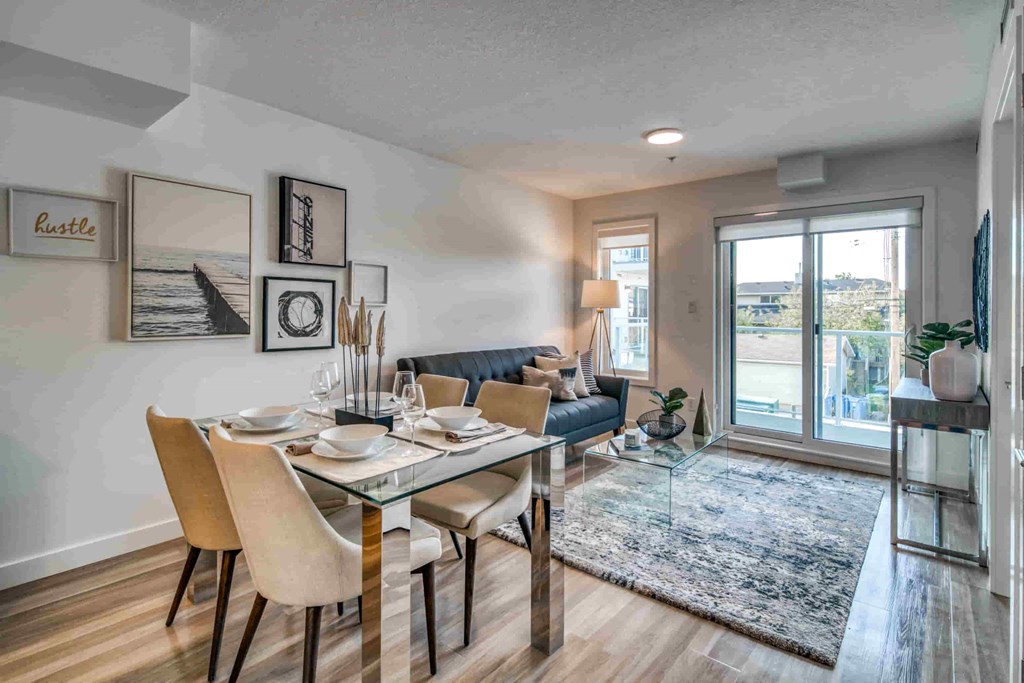 a dining room with a table and chairs next to a living room