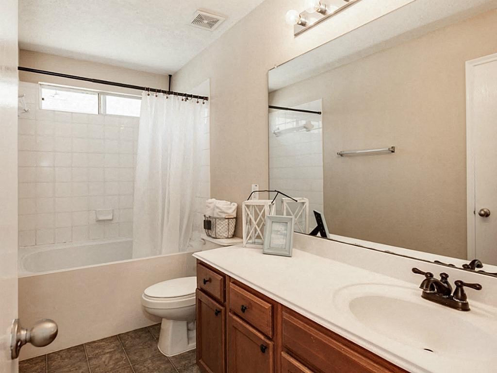 a bathroom with a sink toilet and a mirror