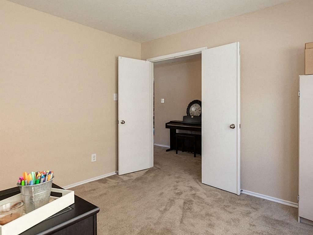 a living room with an open door to a bedroom