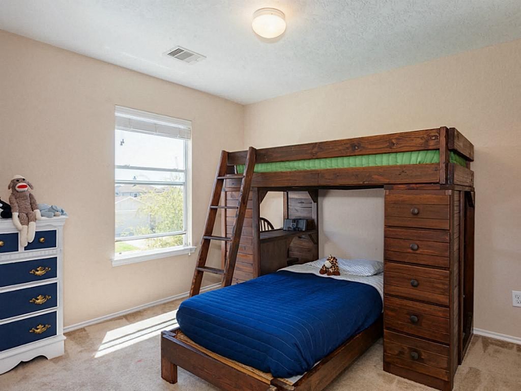 a bunk bed in a bedroom with a ladder