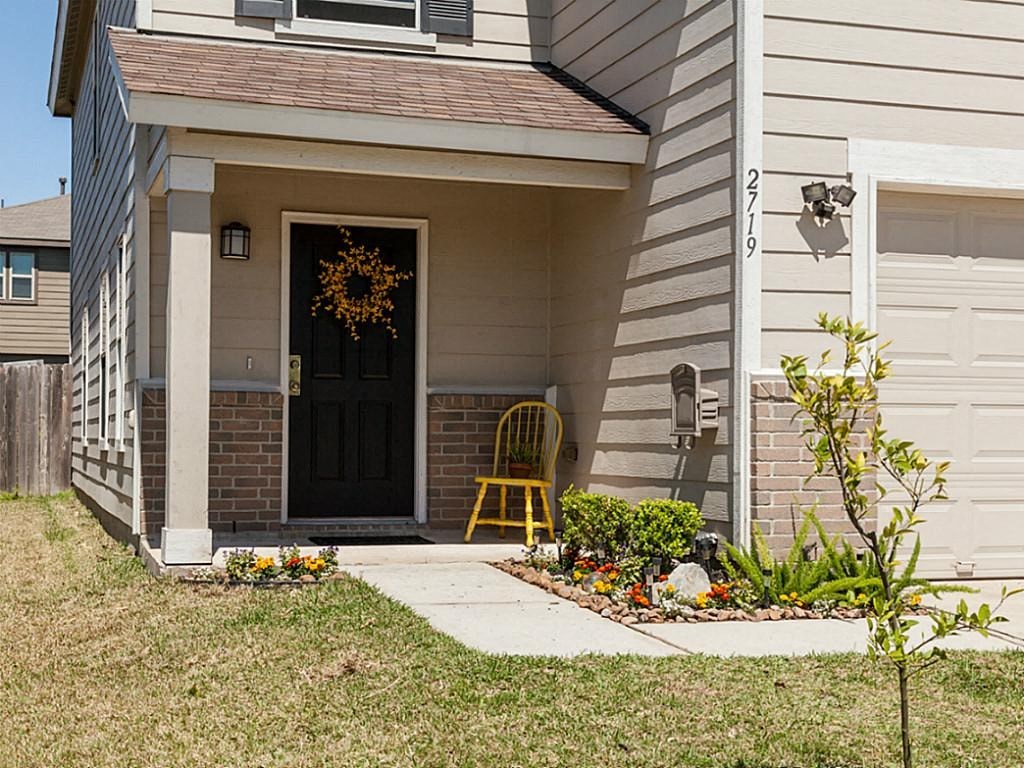 a porch with a yellow chair in front of a house