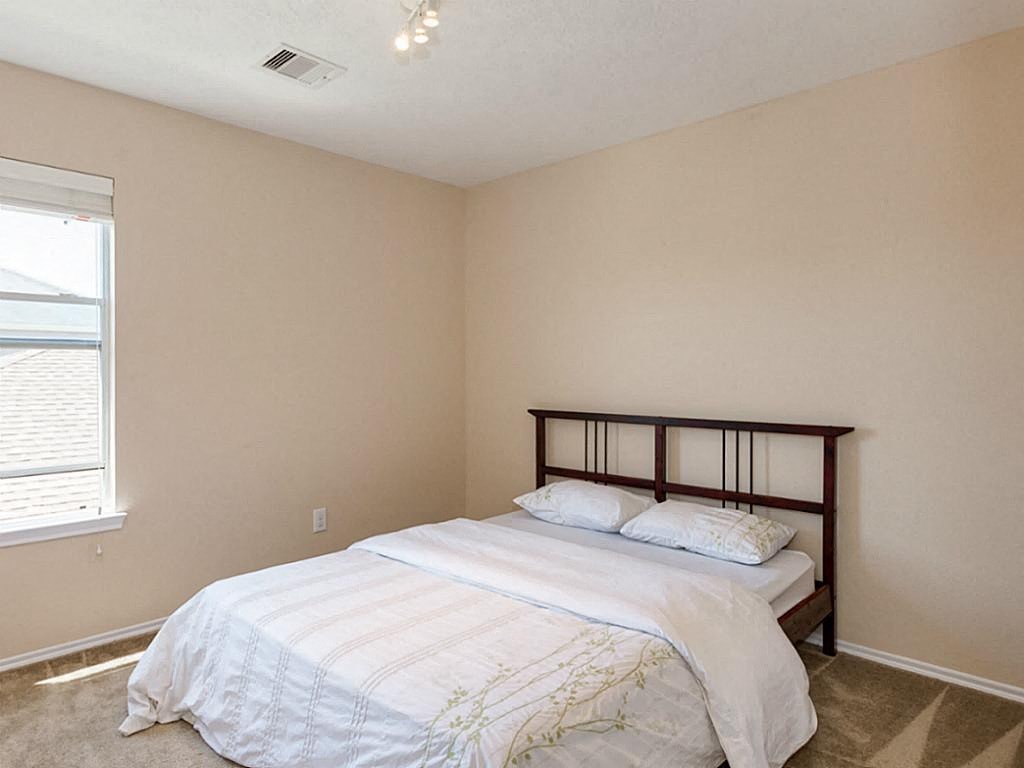 a bedroom with a bed and a window