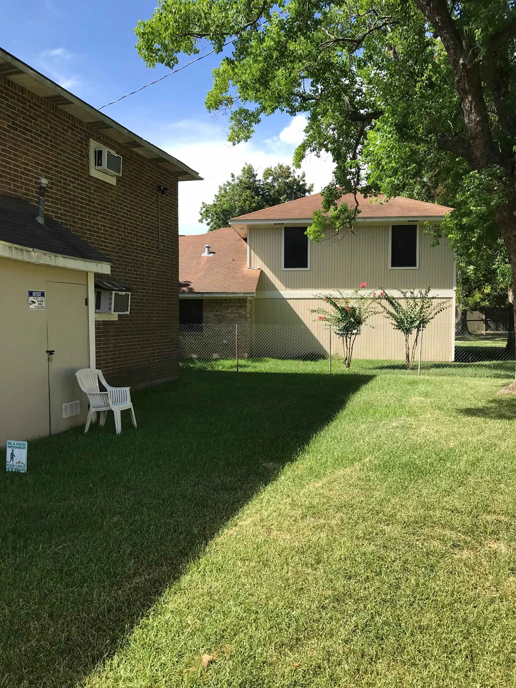 a backyard with a lawn and a house