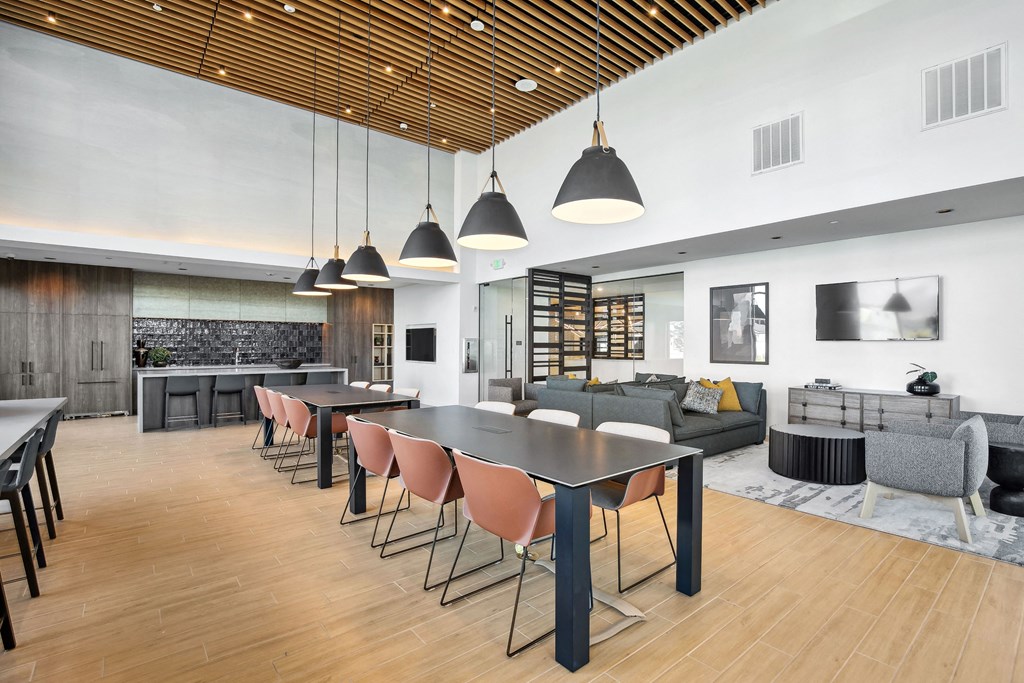 a dining room with tables and chairs and a living room