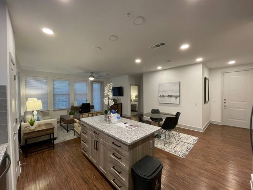a living room with a kitchen and a dining room