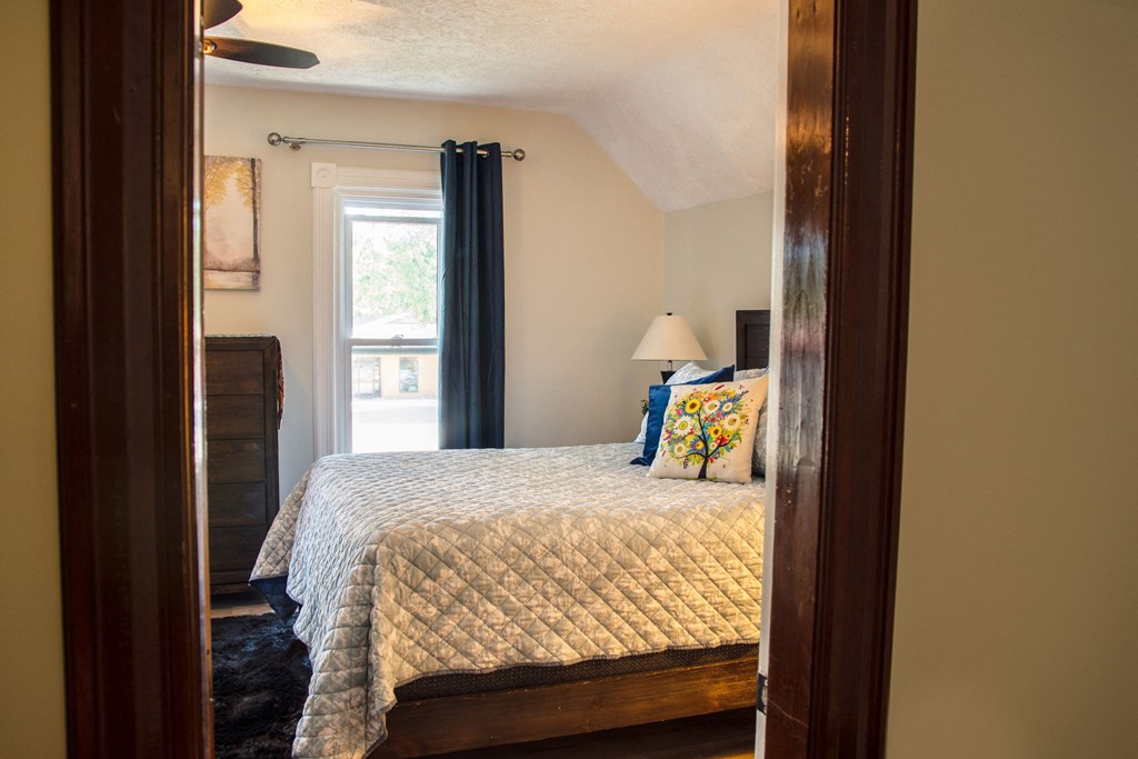 a bedroom with a bed and a window