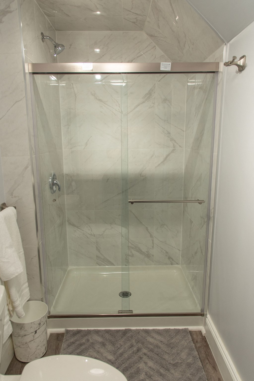 a shower with a glass door in a bathroom