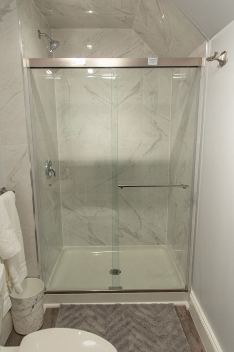 a shower with a glass door in a bathroom