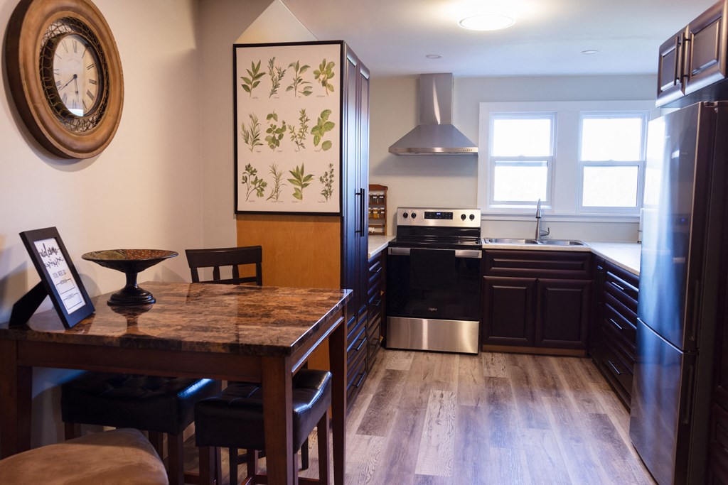 a kitchen and dining room with a table and chairs