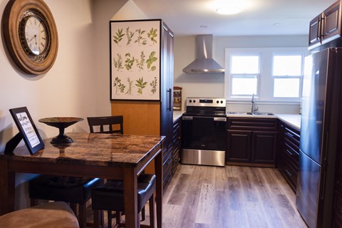a kitchen and dining room with a table and chairs