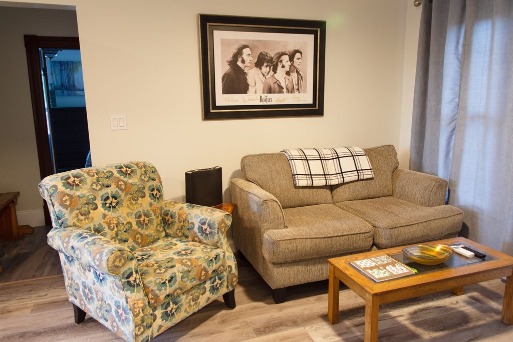 a living room with a couch and chair and a coffee table