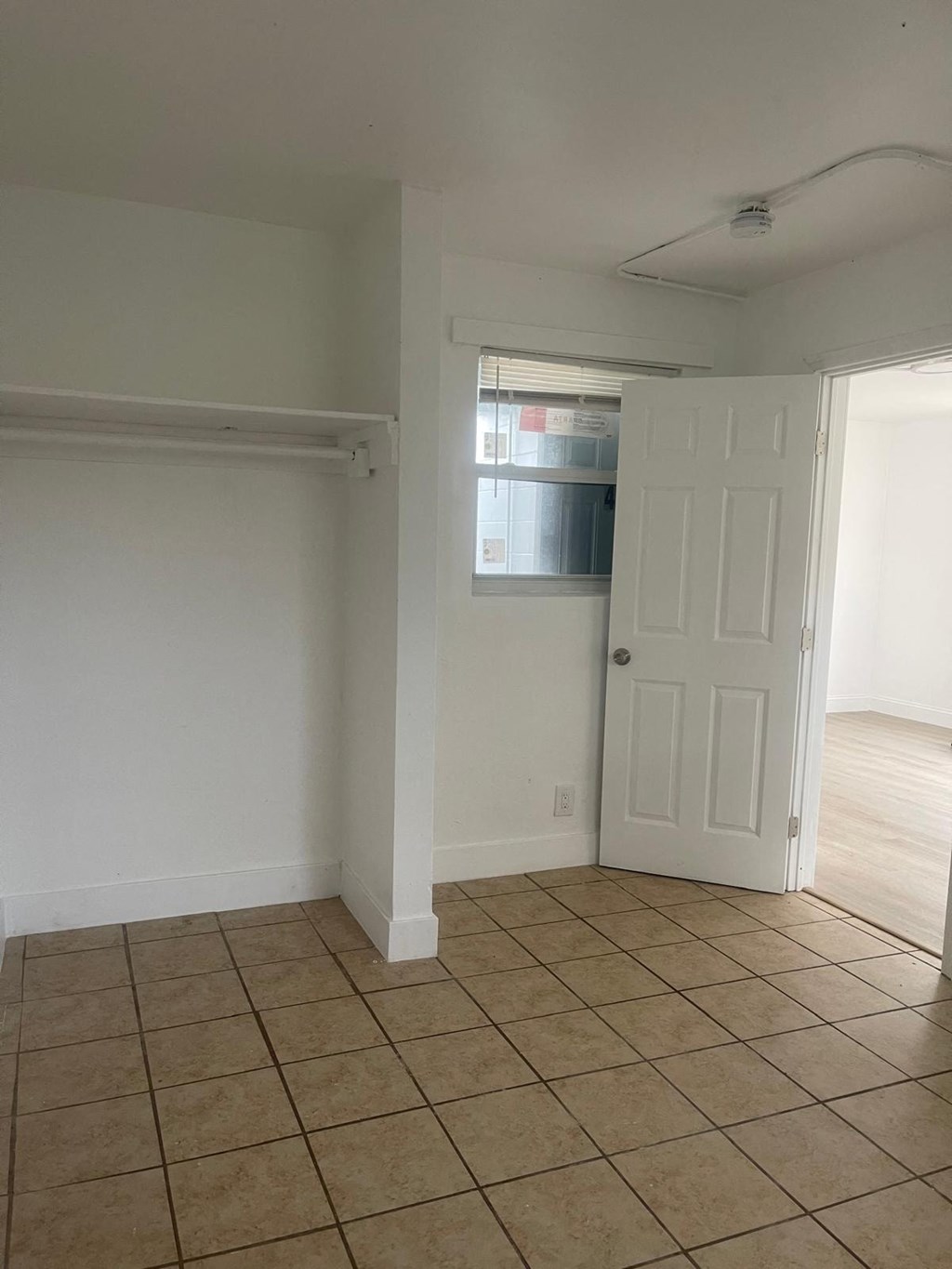 A room with white walls and a white door.