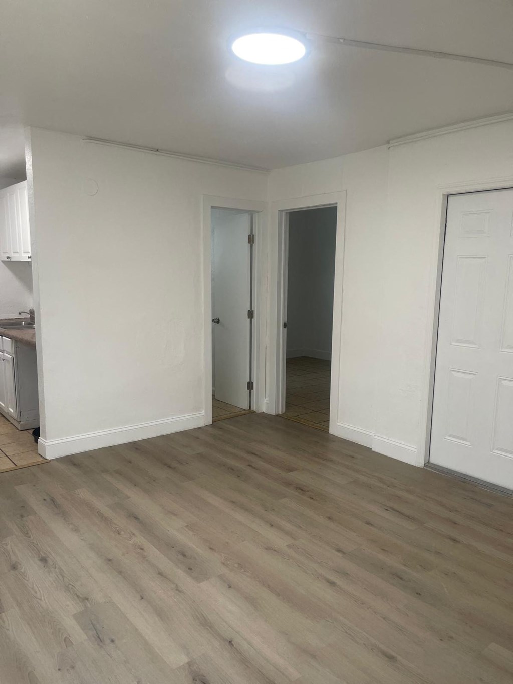 A room with a wooden floor and white walls.