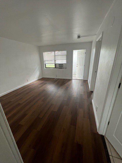 A room with wooden floors and white walls.