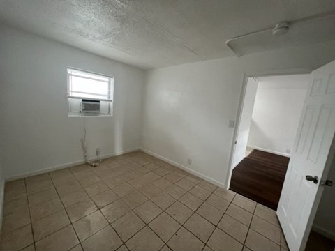 A room with a tiled floor and a window.