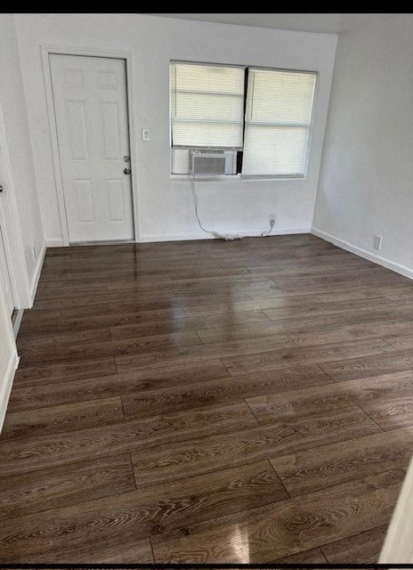 a living room with a hard wood floor and a window
