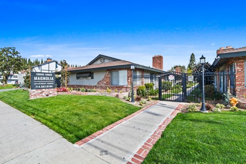 the front of a house with a yard and a sign that reads madison avenue