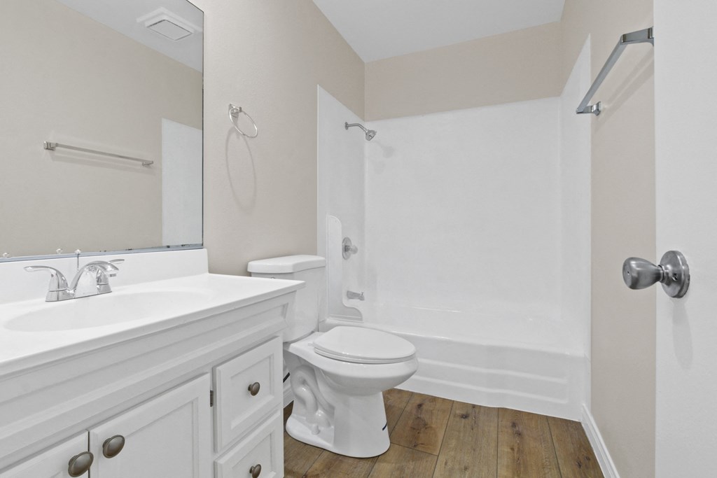 a bathroom with a toilet and a sink and a shower