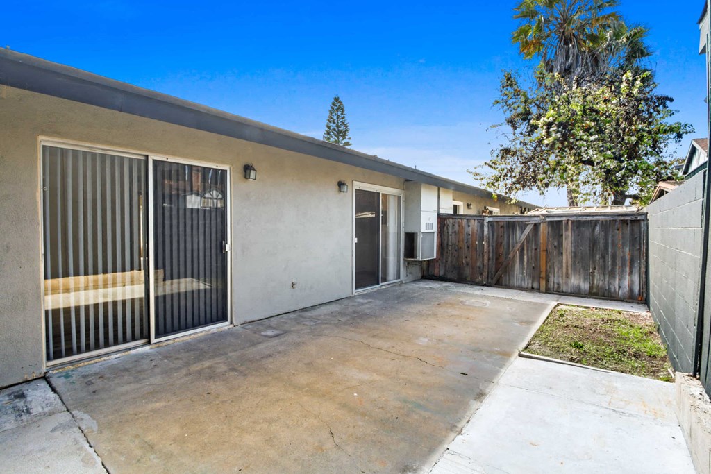 the driveway of a house with a garage door and a fence