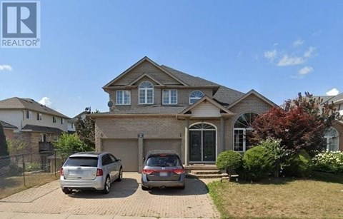 a house with two cars parked in front of it