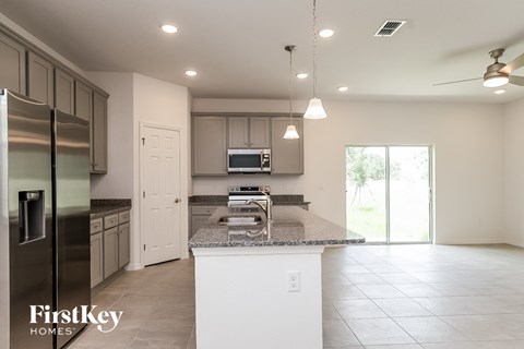 a kitchen with granite counter tops and stainless steel appliances