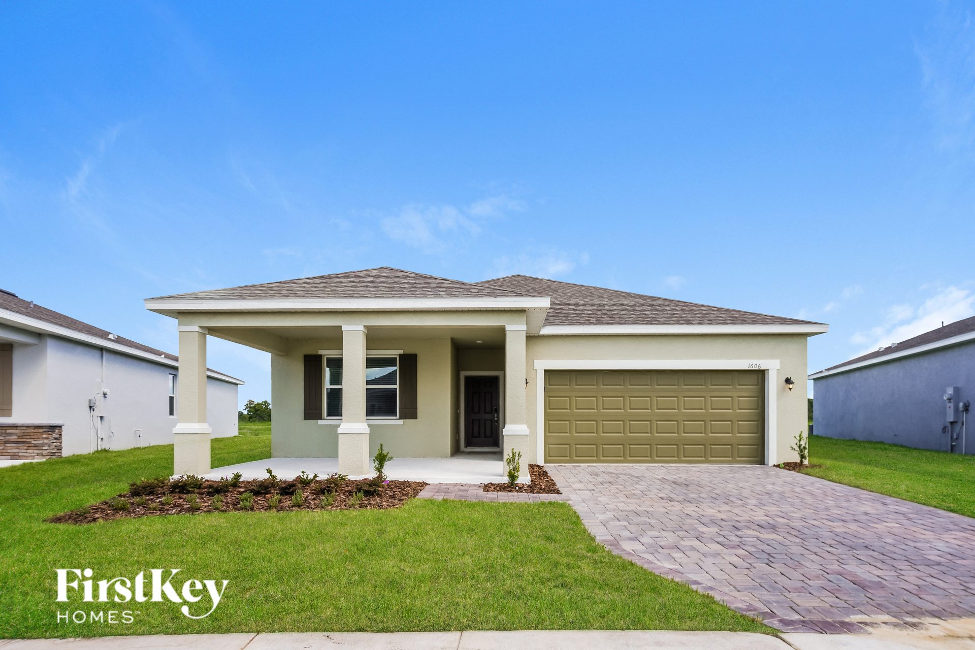 a house with a garage door and a lawn