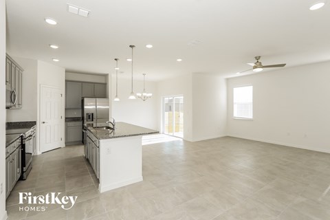 A spacious kitchen and living room with a modern design.
