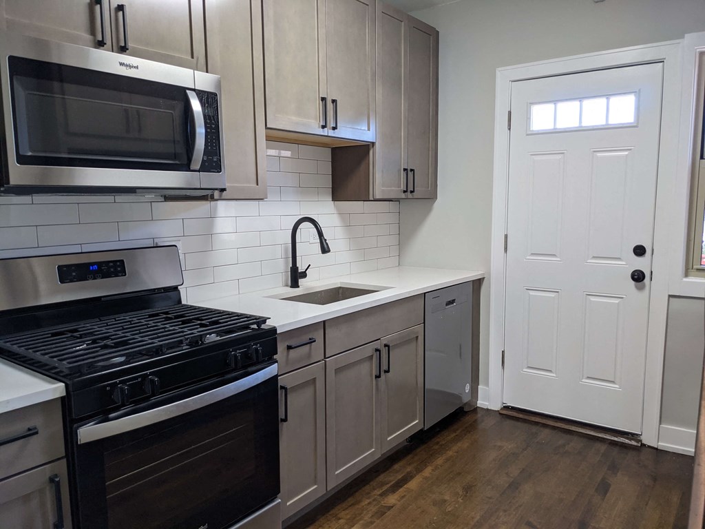 a kitchen with stainless steel appliances and white cabinets