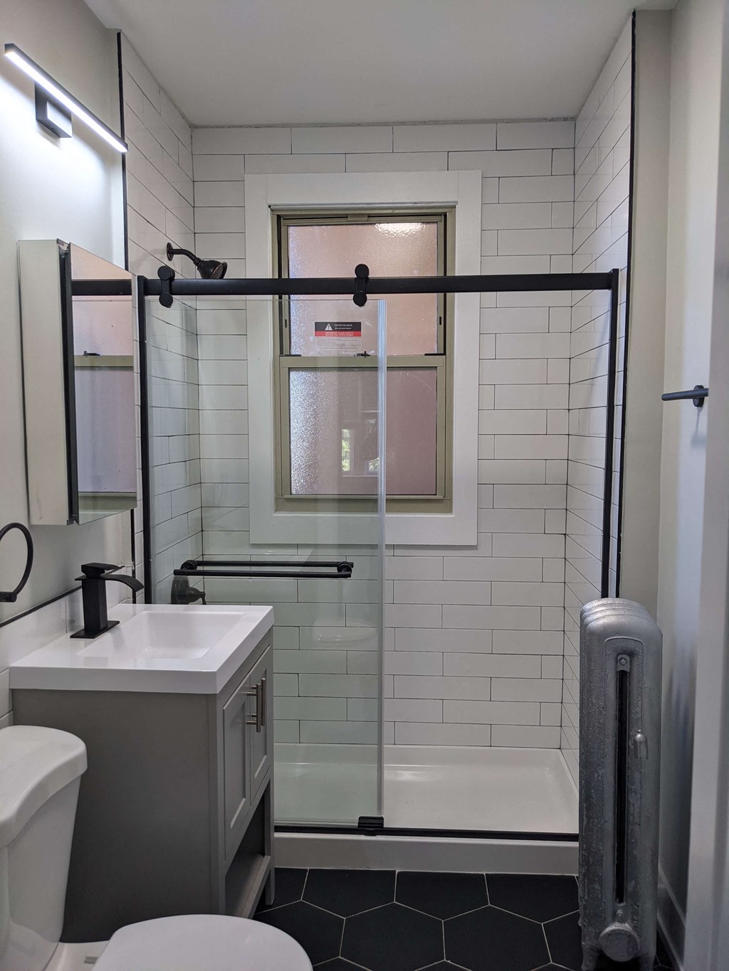 a bathroom with a shower and a sink and a toilet