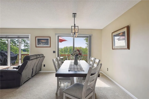 a dining room with a table and chairs and a window