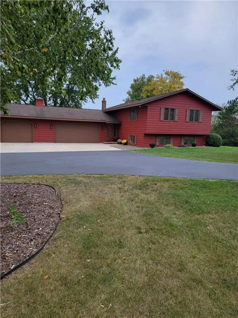 a red house on the side of a road