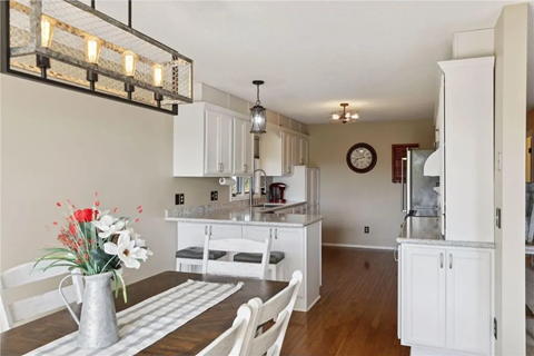 an open kitchen and dining room with a table and chairs