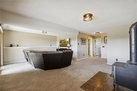 a living room with a leather couch and a fireplace