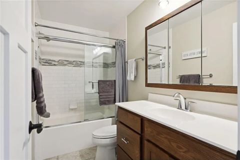 a bathroom with a sink and a shower and a toilet