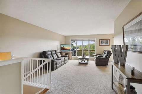 a living room with a staircase in front of a window