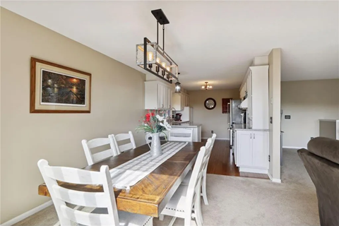 a dining room with a wooden table and chairs
