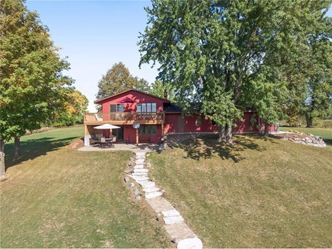 a view of the house from the hill above it