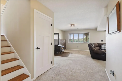 a living room with a couch and a staircase in a house