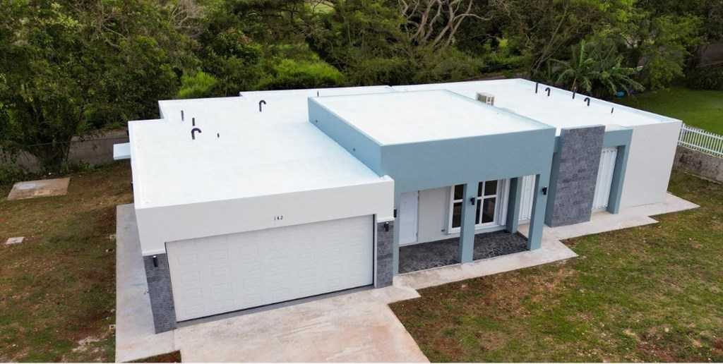 an aerial view of a white and blue house