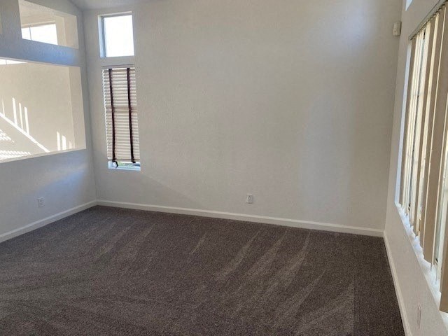 an empty room with white walls and a window