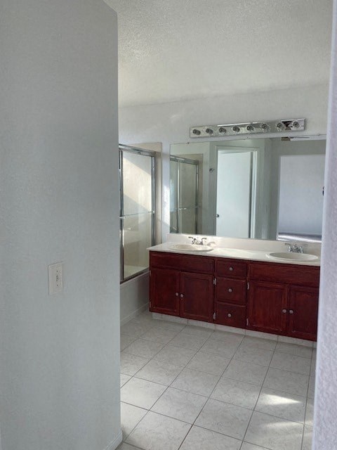 an empty bathroom with a sink and a mirror