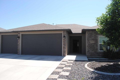 the front of a house with a driveway and a garage door