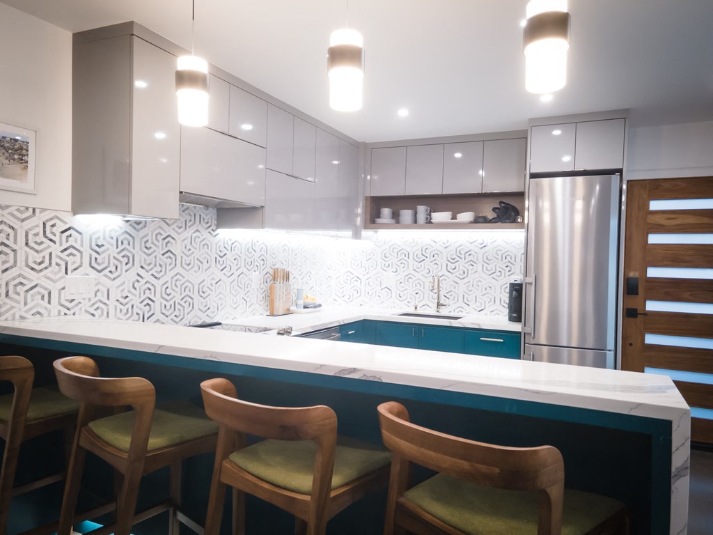 a kitchen with a white counter top and a blue sink