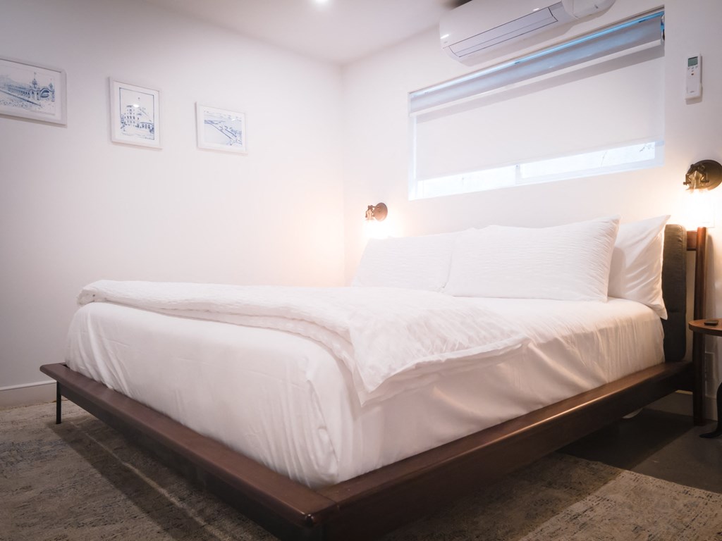 a bedroom with a bed and a window