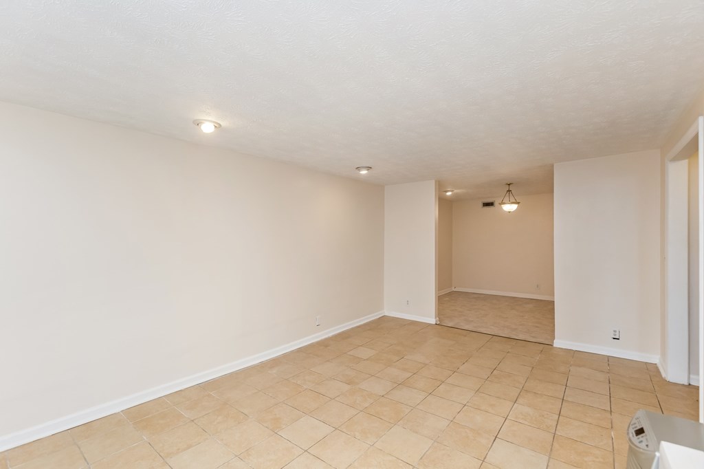 Empty room with tiled floor and white walls.