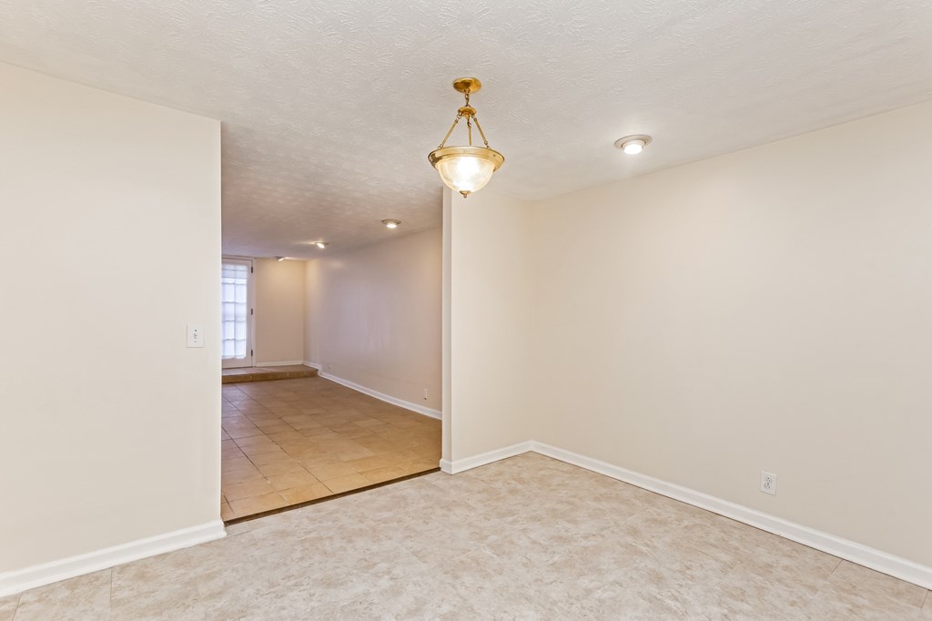 A room with a light fixture hanging from the ceiling.
