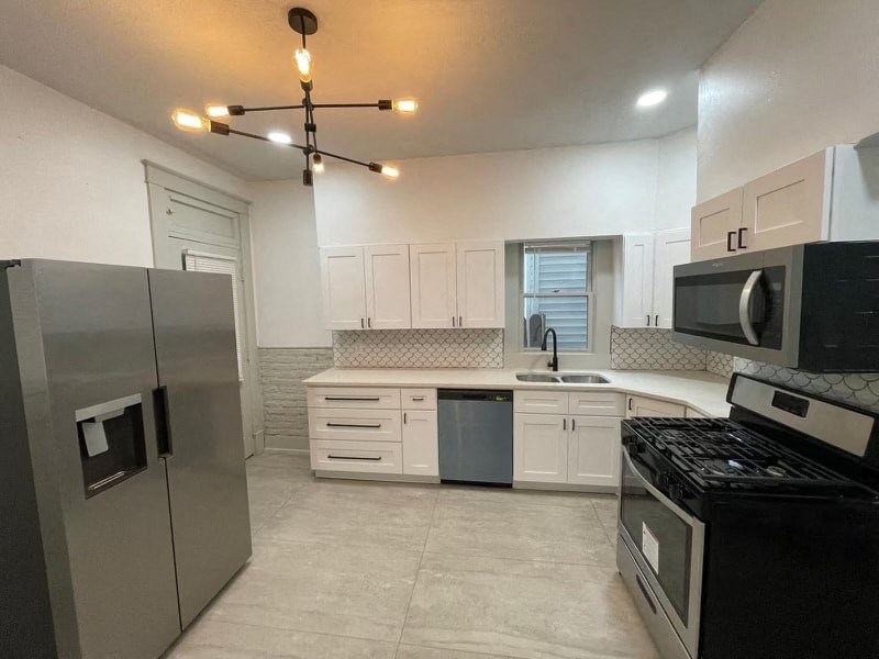 a kitchen with stainless steel appliances and white cabinets